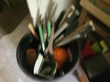 a bowl of utensils and other kitchen utensils in it