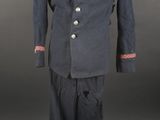 an old uniform with red trimmings and buttons on a mannequin