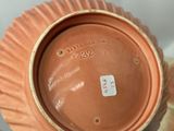 a brown vase that has a label on it