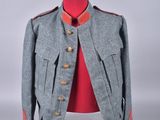 an image of a grey jacket with red trims on a mannequin stand