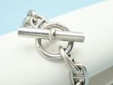 a close up of a silver ring on a white napkin