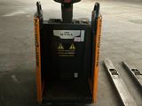 a forklift that is sitting in a warehouse