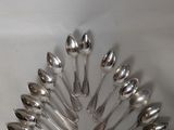a lot of spoons arranged in a circle on the table