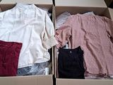 two boxes with clothes in them sitting on a table