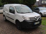 a small white van parked on the side of the road