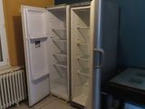 a refrigerator and a table in a room with blue walls