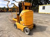 a small yellow machine that is parked in the dirt