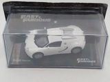 a white toy car in a clear box on a table