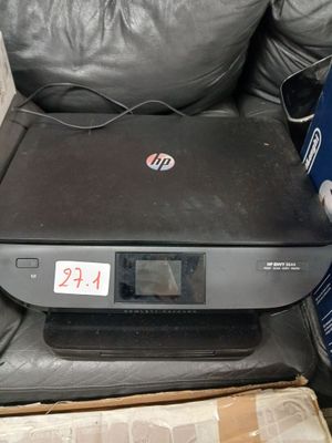 a printer sitting on top of a black leather chair