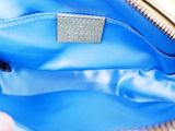 a person holding a blue purse in their hand