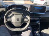 a man sitting in the driver ' s seat of a car