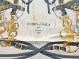a white and gold scarf with horses and horses on it