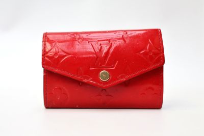 a red louis vuitti wallet with gold hardware
