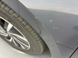 a close up of a car ' s front bumper with scratches on it