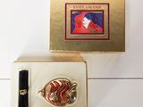an image of a box containing a ring and a box with a picture of a woman in a red dress