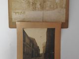 two old photos of a street and a train on a wall