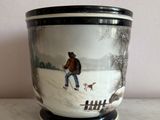 a pot that has a picture of a man and a dog on it