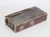 an old book that is sitting on a white surface