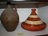 two vases sitting on a shelf next to each other