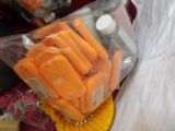 a bag of carrots sitting on top of a table