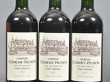 three bottles of red wine sitting next to each other on a table