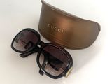 Lunettes de soleil Gucci noires et dorées avec étui