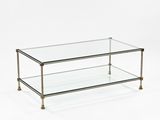 a glass coffee table with brass legs and a glass top