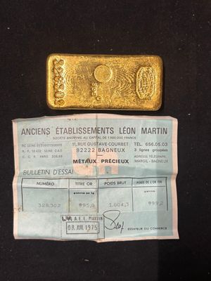 an image of a gold bar sitting next to a piece of paper