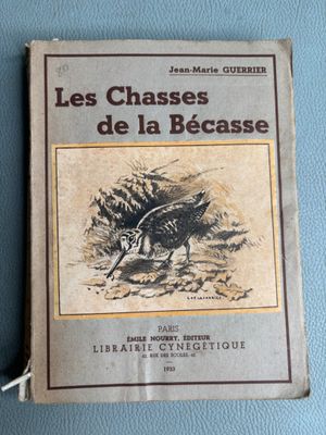 an old book with a drawing of a bird on the cover