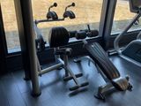 a view of a gym room with equipment and a large window