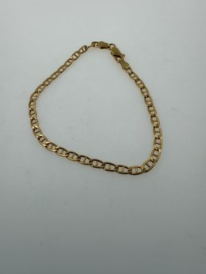 a gold chain bracelet on a white background
