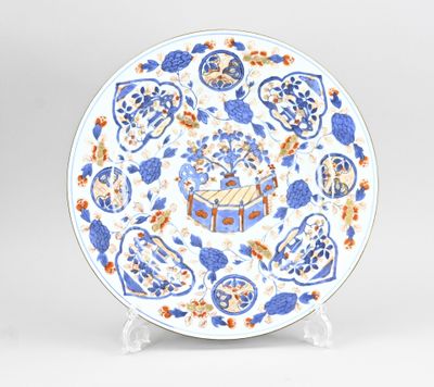 une assiette bleue et blanche ornée de motifs bleus et orange
