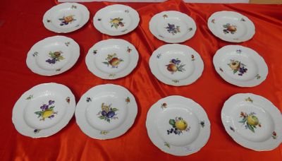 many plates that are on a red table cloth