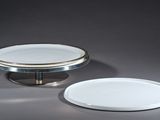 a white plate and a silver plate sitting on a table