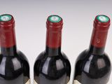 three bottles of wine sitting next to each other on a table