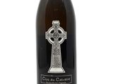 a bottle of wine with a celtic cross on it