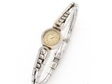 a close up of a wrist watch on a white surface