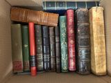 a box full of old books sitting on a table