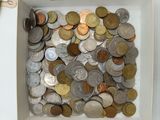 a white box filled with lots of coins and a pair of scissors