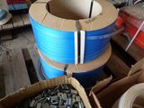 many rolls of blue and white wires in a box