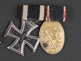 two medals and a medal on a black surface