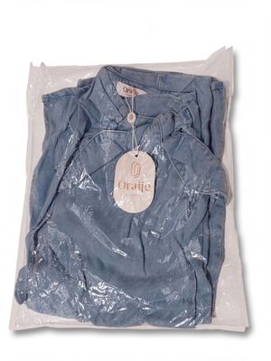 a blue shirt in a plastic bag with a tag on it