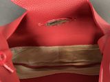 the inside of a red leather purse with a metal handle
