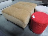 two ottomans and a table in a room