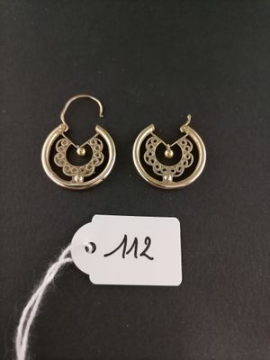 a pair of earrings with a price tag on a black background