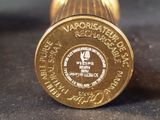 a close up view of a gold medal on a black surface