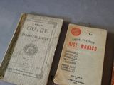 several old books are sitting on a table next to each other