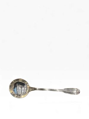 a silver spoon with a blue stone in it