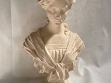 marble bust of a woman with a wreath of flowers on her head