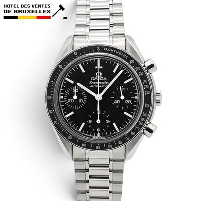 a close up of a watch on a white surface with a black dial